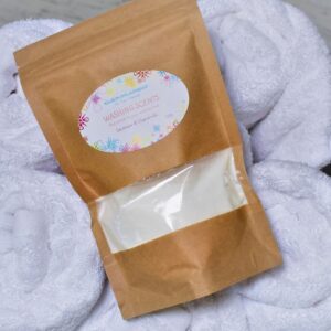 Packet of 'washing scents lavender and chamomile' on towels in basket
